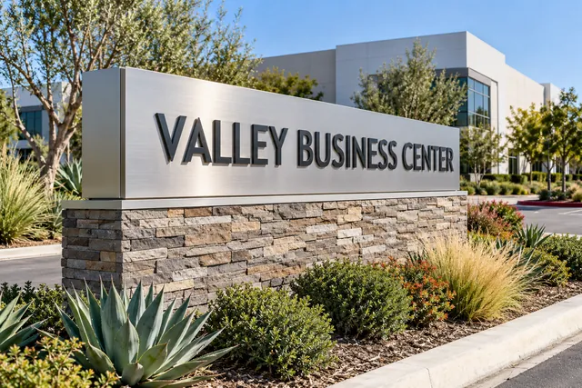 Illustration: stone and aluminum monument sign at a business center entrance