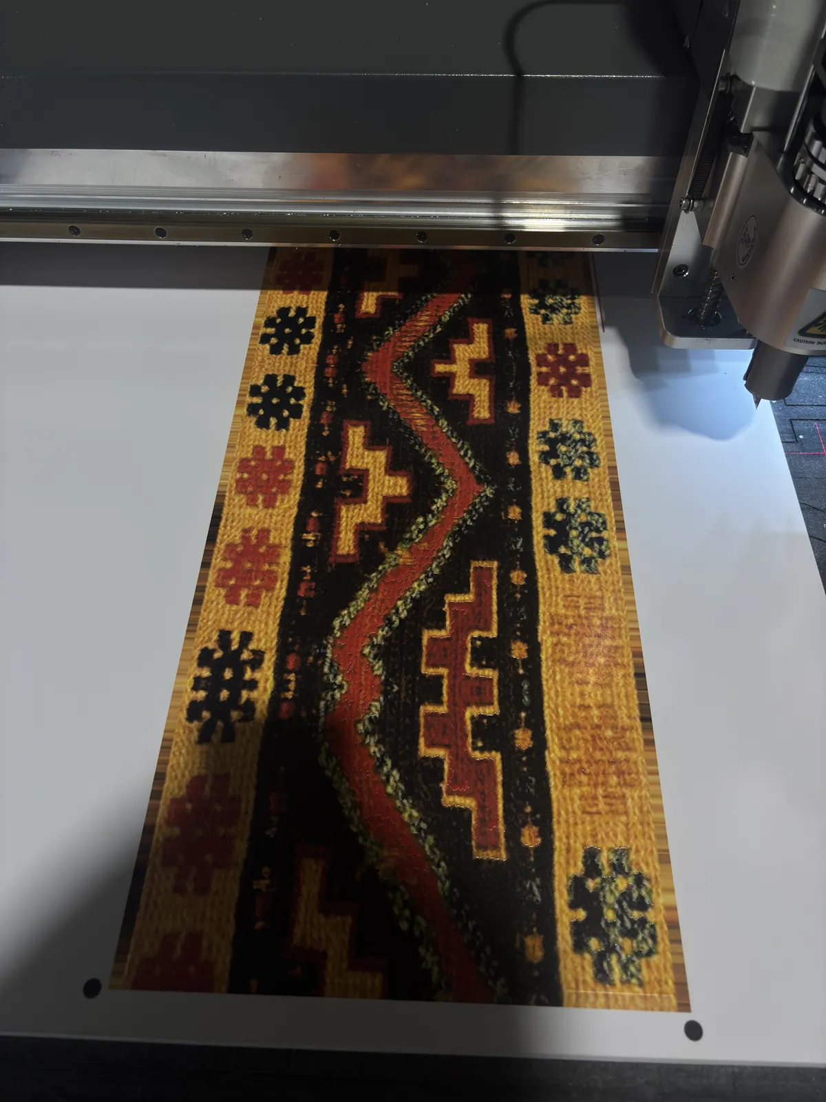 A printed panel with a woven pattern on the flatbed cutter in our shop
