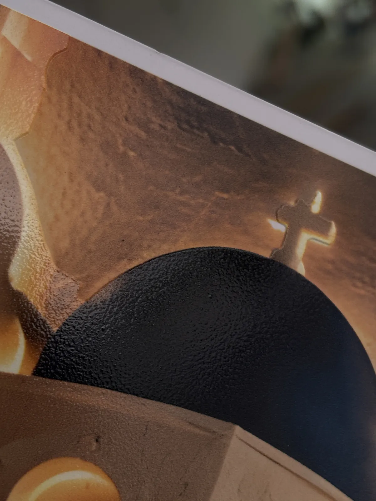 Close-up of raised UV ink texture on a printed dome and cross
